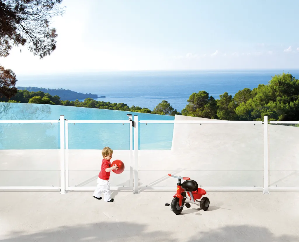 TWIST40_STK_SWING40__Child_with_red_ball_at_white_swimming_pool_fence__1920px.webp