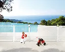 TWIST40_STK_SWING40__Child_with_red_ball_at_white_swimming_pool_fence__1920px.webp